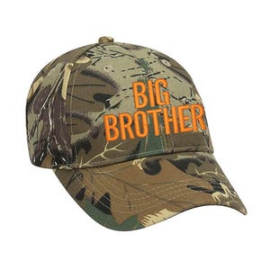 May include: Camouflage baseball cap with the words "BIG BROTHER" embroidered in orange.
