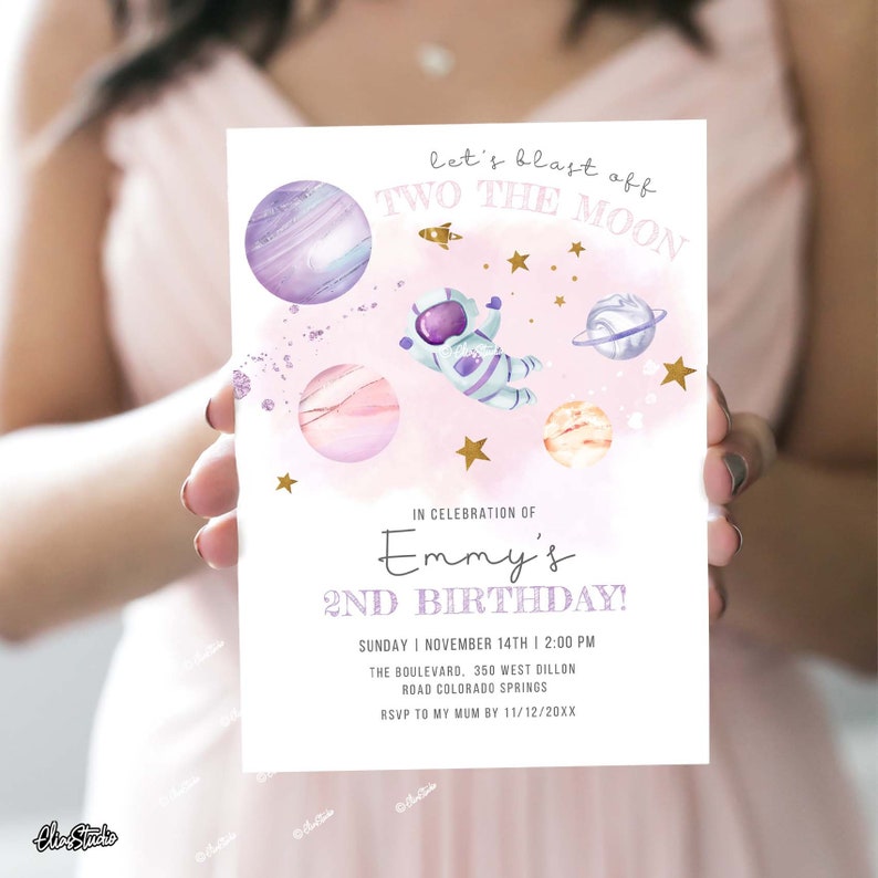 May include: A pink and purple space-themed birthday invitation with a cartoon astronaut and planets. The text reads "Let's blast off Two the Moon" and "Emmy's 2nd Birthday!"  Sunday, November 14th, 2:00 PM. The Boulevard, 350 West Dillon Road, Colorado Springs. RSVP to my Mum by 11/12/20XX.