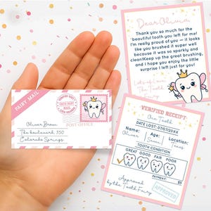 May include: A collection of tooth fairy-themed stationery, including a pink and white envelope with "Fairy Mail" and a stamp featuring a cartoon tooth. There are also two cards with handwritten messages and a receipt.