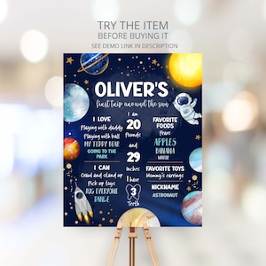 May include: A blue and gold space-themed first birthday milestone poster with the name Oliver. The poster features a rocket, planets, stars, and an astronaut. It includes details like Oliver's age, weight, height, favorite foods, and toys.