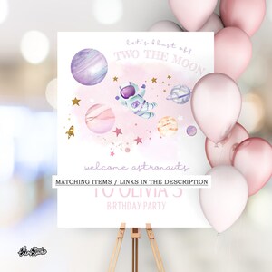 May include: Pink welcome sign with a watercolor illustration of an astronaut, planets, and stars. The text reads "Let's blast off two the moon, welcome astronauts, to Olivia's birthday party".