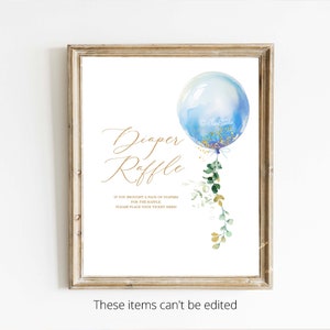 May include: A blue and gold diaper raffle sign with a watercolour balloon and greenery. The sign reads "Diaper Raffle" and "If you brought a pack of diapers for the raffle, please place your ticket here!"