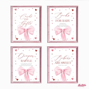 May include: Four pink and white printable signs with a pink bow and red hearts. The signs say "Cards and Gifts", "Books for Baby", "Diaper Raffle", and "Babies are Sweet".