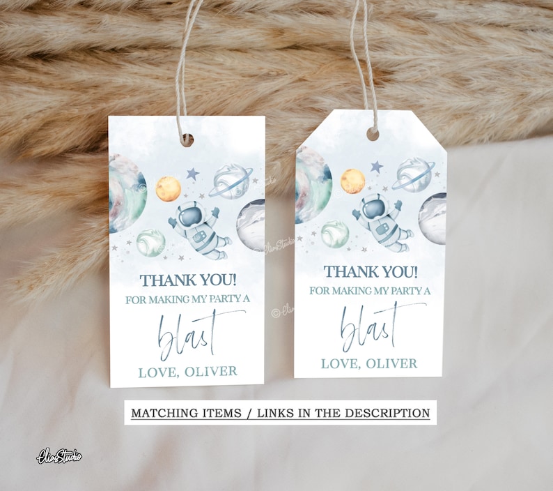 May include: Two blue and white thank you tags with an astronaut and planets. The text reads "Thank you! For making my party a blast. Love, Oliver."