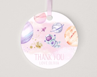 May include: Round pink and white thank you tag with an astronaut, planets, and stars. The text reads "Thank You Love, Olivia".