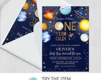 May include: A blue and gold space-themed first birthday party invitation with planets, stars, and a rocket ship. The text reads "Houston, we have a one year old!" and "Please join us as we celebrate Oliver's first trip around the sun."