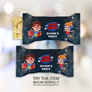 May include: A black and blue snack bag with a superhero theme. The bag features a boy and girl dressed as superheroes. The text on the bag reads "Super Heroes Oliver's Party".