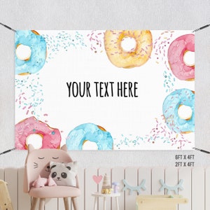 May include: A white backdrop with a donut theme. The background is decorated with colourful sprinkles. The text "YOUR TEXT HERE" is in the centre of the backdrop. There are six donuts in various colours, including pink, blue, and yellow.