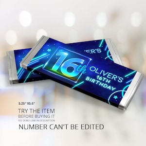 May include: A blue and black chocolate bar wrapper with neon blue accents and a silver foil border. The wrapper features the number 16 in a glowing yellow and blue font with the word "th" in a smaller font. The text "Oliver's 16th Birthday" is also on the wrapper.