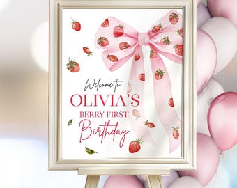 Könnte beinhalten: Ein weißes Schild mit einer rosa Schleife und roten Erdbeeren. Auf dem Schild steht "Willkommen zu Olivia's Berry First Birthday".