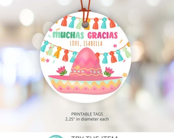 May include: A round, white printable tag with a colorful sombrero and the text "MUCHAS GRACIAS LOVE, ISABELLA". The tag is 2.25 inches in diameter.