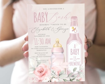 May include: Pink and white baby shower invitation with a pink bottle and a baby bottle with a pink and white floral design. The text reads "You are invited to a Baby Bash honoring parents-to-be Elizabeth & George. Saturday, November 1st, 20XX, 11:30 AM, Baby Club Hotel, 700 Third Avenue Seattle, Washington. RSVP by June 1st to Olivia. Call or text 021000000. Registered by -Baby Baby- A Baby is Brewing."