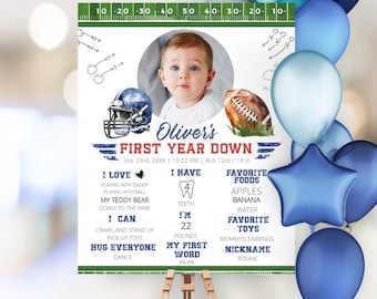 May include: A blue and green football-themed first birthday sign with a photo of a baby boy. The sign includes the baby's name, Oliver, and details about his first year, including his weight, height, favorite foods, and first word.