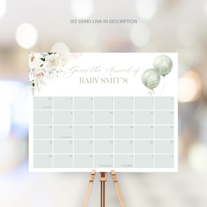 May include: A white and green baby shower game sign with the text "Guess the Arrival of Baby Smit's" and a calendar with dates from August 30th to October 3rd. The sign features a floral design with white roses and green leaves. There are two green balloons with white text on them.