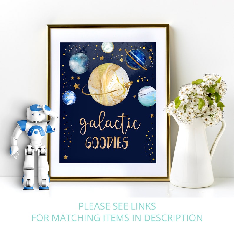 May include: A printable sign with a navy blue background and gold lettering that says "galactic goodies". The sign features a watercolor illustration of planets and stars.
