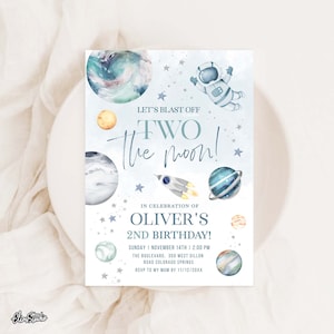 May include: A blue and white invitation card with a space theme. It says "Let's Blast Off Two the Moon!" and "Oliver's 2nd Birthday!" with planets, stars, a rocket, and an astronaut.