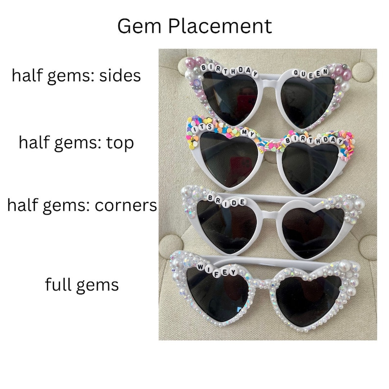 May include: Four pairs of white heart-shaped sunglasses with different embellishments. The top pair has pink and white gems and the text "Birthday Queen". The second pair has colorful gems and the text "It's My Birthday". The third pair has white gems and the text "Bride". The bottom pair has white gems and the text "Wifey".
