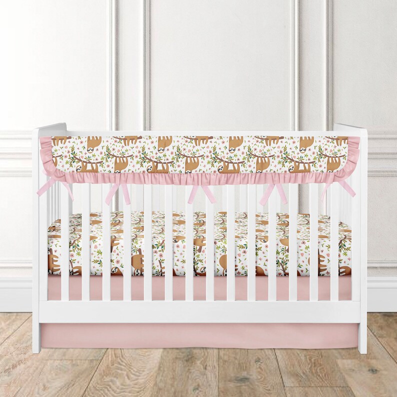 Bedding set in crib for a girl with a sloth bumper coral Etsy