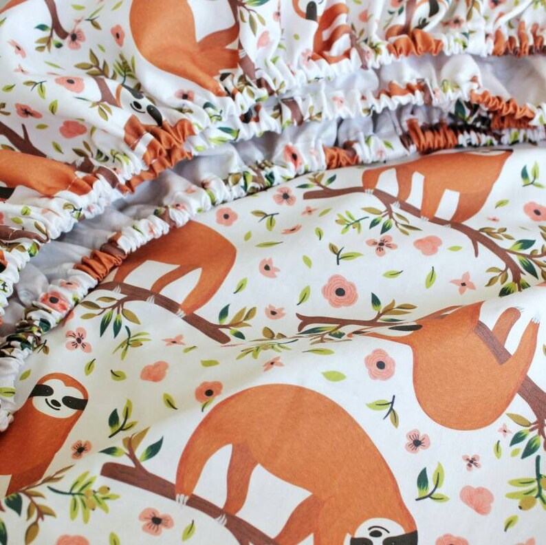 Bedding set in crib for a girl with a sloth bumper coral Etsy