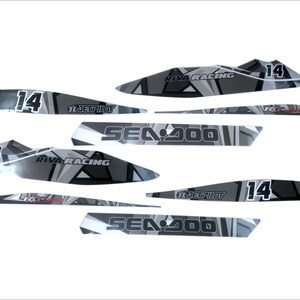 May include: A set of black and gray Sea-Doo watercraft decals with a geometric design. The decals feature the text "Sea-Doo", "Riva Racing", and "Jetpilot", along with the number "14".
