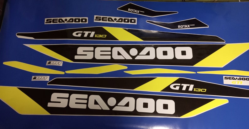 May include: A set of black and yellow Sea-Doo decals with the text "Sea-Doo", "GTI 130", and "ROTAX" in white.