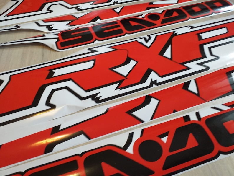 May include: Multiple red and black Sea-Doo stickers with the word "Sea-Doo" and the logo "RXP" in white.