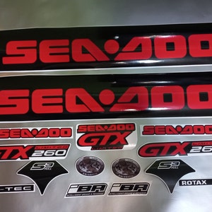 May include: A set of black and red Sea-Doo decals with the text "Sea-Doo", "GTX", "Limited", "260", "S3 Hull", "Rotax 4-Tec", and "iBR" in white and black lettering.