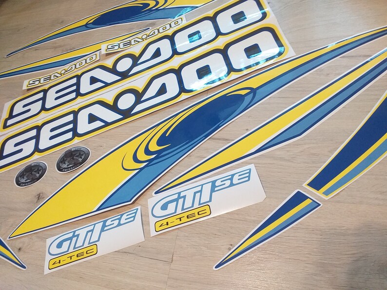 May include: A set of yellow and blue Sea-Doo decals with the text "Sea-Doo" and "Sea 400" and "GTi SE 4-TEC".