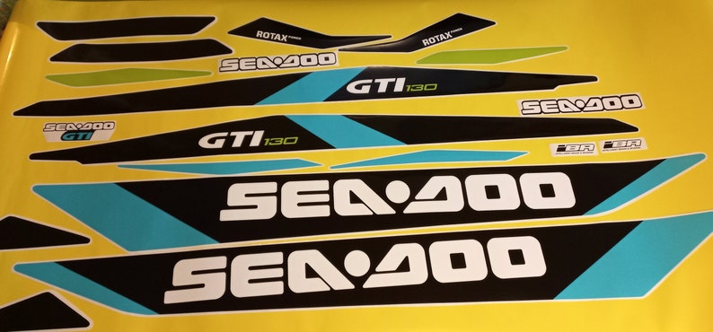 以下が含まれることがあります： 黒、白、ターコイズブルーのシー-ドゥー水上バイク用デカールセット。デカールには、シー-ドゥーのロゴと「シー-ドゥー」、「GTI 130」、「ROTAX」の文字が書かれています。