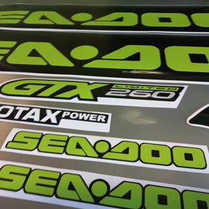 May include: A set of black and green Sea-Doo decals with the text "Sea-Doo", "GTX Limited 260", and "Rotax Power".