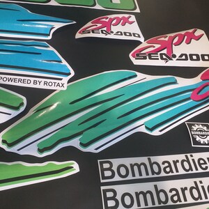 Puede incluir: Un conjunto de calcoman&iacute;as para una moto acu&aacute;tica Sea-Doo SPX 400. Las calcoman&iacute;as son de color negro, blanco, verde, azul y rosa. Las calcoman&iacute;as presentan el logotipo de Sea-Doo, el nombre del modelo SPX 400 y las palabras "Powered by Rotax". Las calcoman&iacute;as tambi&eacute;n presentan un logotipo de Bombardier.