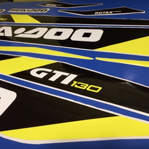 May include: A set of black and yellow Sea-Doo decals with the text "Sea-Doo", "GTI 130", and "ROTAX POWER".