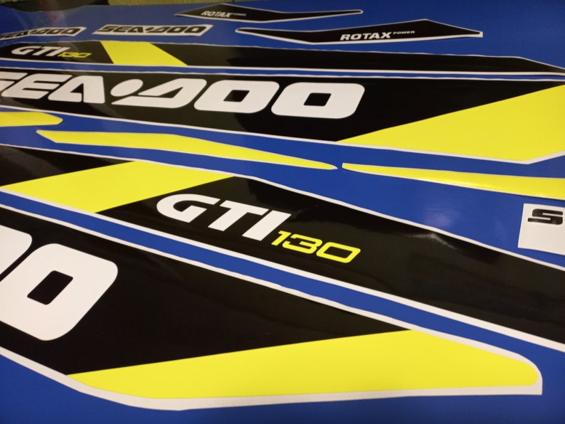 May include: A set of black and yellow Sea-Doo decals with the text "Sea-Doo", "GTI 130", and "ROTAX POWER".