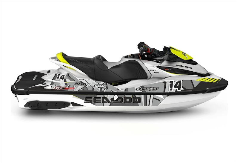 May include: A white Sea-Doo Spark jet ski with black and gray graphics. The jet ski has a yellow and black racing number "14" on the side. The jet ski also has the words "Riva Racing" and "Jet Pilot" on the side.