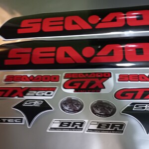 May include: A set of black and red Sea-Doo decals with the text "Sea-Doo GTX 260 Limited" and "Sea-Doo GTX 2".