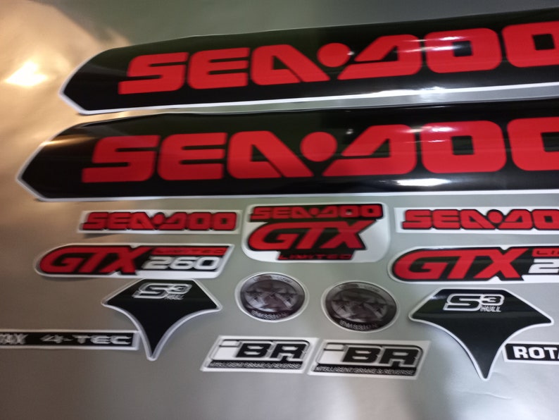 May include: A set of black and red Sea-Doo decals with the text "Sea-Doo GTX 260 Limited" and "Sea-Doo GTX 2".