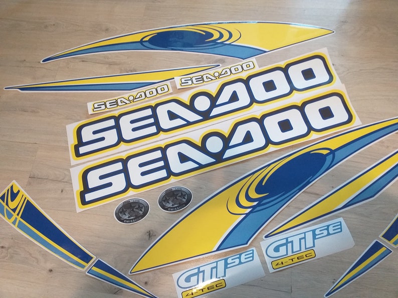 May include: A set of yellow and blue Sea-Doo watercraft decals. The decals feature the Sea-Doo logo and the text "Sea-Doo" and "GTISe 4-TEC".