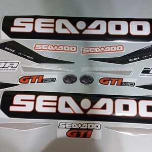 May include: A set of black and white Sea-Doo decals with orange accents. The decals feature the Sea-Doo logo, the model name "Sea-Doo 400", and the text "GTI 130".