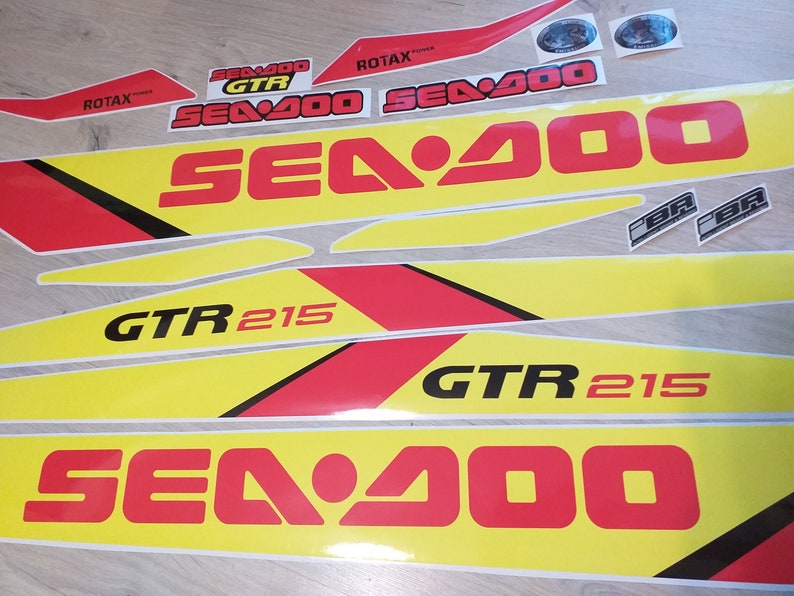 May include: A set of yellow and red decals with the text "Sea-Doo" and "GTR 215".