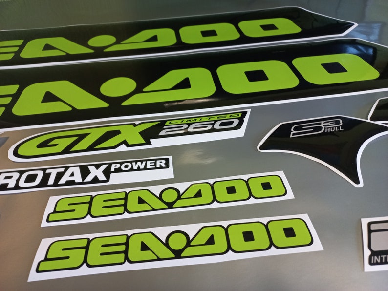 May include: A set of black and green Sea-Doo decals with the text "Sea-Doo", "GTX 260 Limited", "Sea-Doo", "Sea-Doo", "S3 Hull", and "Rotax Power".