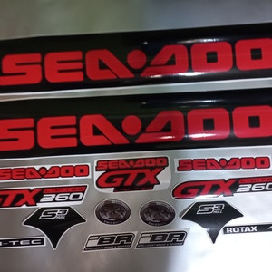 May include: A set of black and red Sea-Doo decals with the text "Sea-Doo", "GTX", "Limited", "260", "S3 Hull", "Rotax 4-Tec", and "PBR" in white.