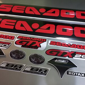 May include: A set of black and red Sea-Doo GTX Limited 260 decals. The decals include the Sea-Doo logo, GTX Limited, 260, S3 Hull, Emission, and Intelligent Brake & Reverse (iBR).