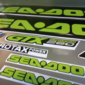 May include: A set of black and green Sea-Doo decals with the text "Sea-Doo", "GTX Limited 260", and "Rotax Power".