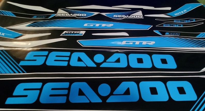 May include: A set of blue and black Sea-Doo decals featuring the text "Sea-Doo", "GTR", and "ROTAX" in white. The decals are designed for a watercraft.