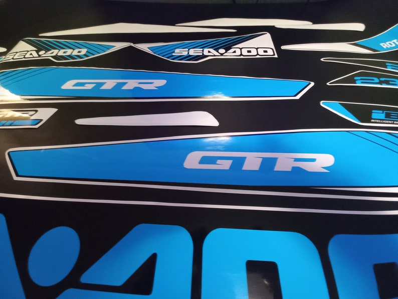 May include: A set of blue and white Sea-Doo GTR decals with the text "Sea-Doo" and "GTR".