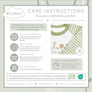May include: Care instructions graphic with a white and green striped long-sleeved shirt. The shirt has a green collar and features a giraffe, lion, and text that reads "I wake up". The graphic also includes washing instructions.