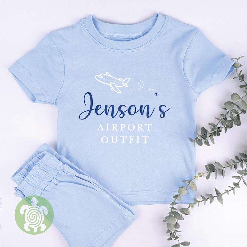 May include: Light blue baby clothes set with a white airplane graphic and the text "Jenson's Airport Outfit".