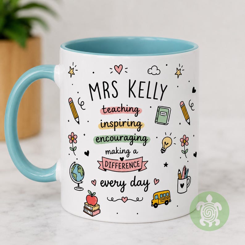 May include: A white ceramic mug with a light blue handle and interior. The exterior features the text MRS KELLY followed by teaching, inspiring, encouraging, making a DIFFERENCE, every day, surrounded by colorful school-themed icons and hearts.