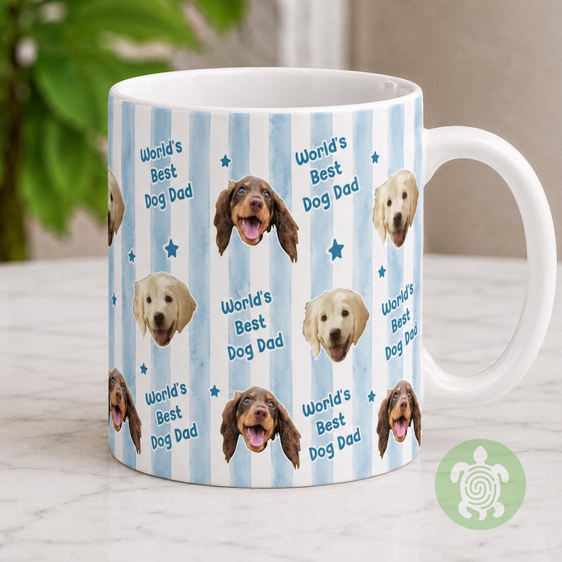 May include: A white ceramic mug featuring a repeating pattern of light blue vertical watercolor stripes, small blue stars, and the text World's Best Dog Dad. The design includes photographic portraits of two different dog breeds with open mouths.
