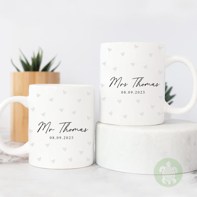 May include: A white ceramic mug with a colorful floral design. The mug features a handle and a wide rim. The flowers are in shades of pink, purple, and yellow. The mug is likely for hot beverages.